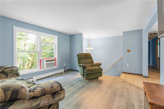 living area featuring a chandelier, cooling unit, baseboard heating, and light hardwood / wood-style flooring