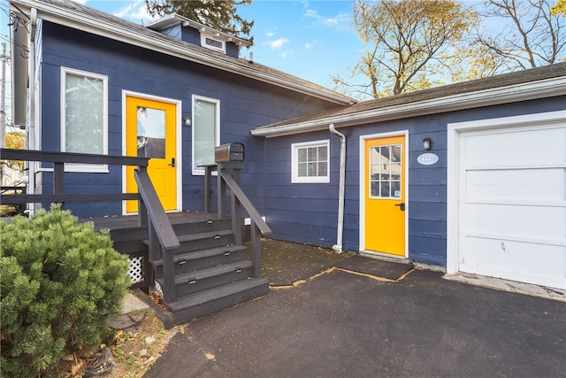 view of exterior entry with a garage