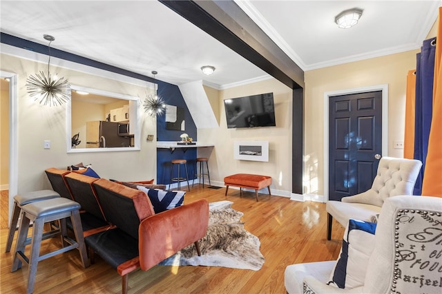 living room featuring wood-type flooring and crown molding