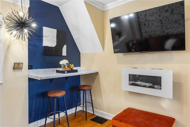 bar featuring hardwood / wood-style floors and crown molding