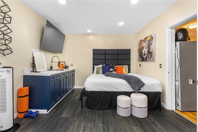 bedroom with sink and dark hardwood / wood-style flooring