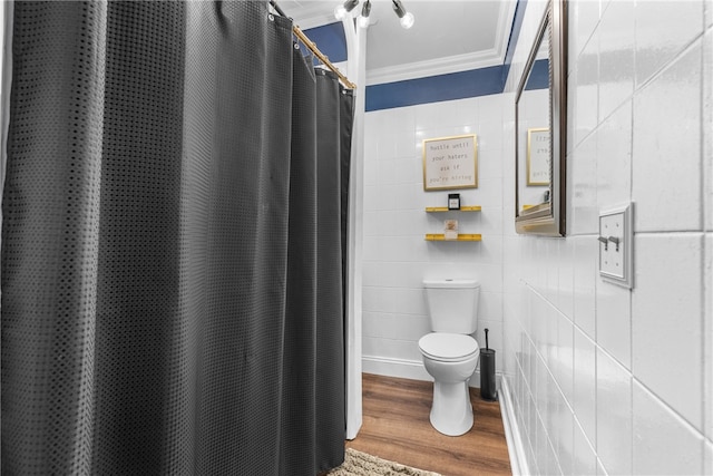 bathroom with tile walls, hardwood / wood-style floors, toilet, and crown molding