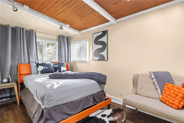 bedroom featuring wooden ceiling, dark hardwood / wood-style floors, rail lighting, beam ceiling, and crown molding