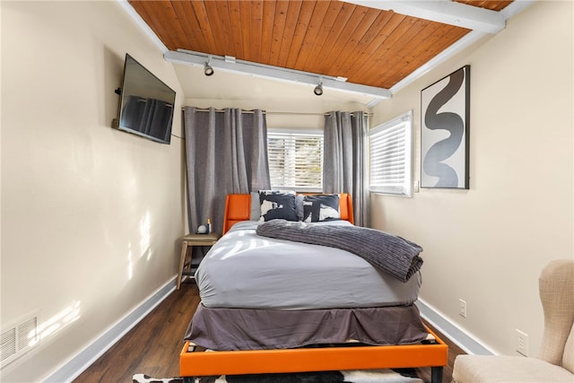 bedroom featuring lofted ceiling with beams, dark hardwood / wood-style flooring, and wooden ceiling