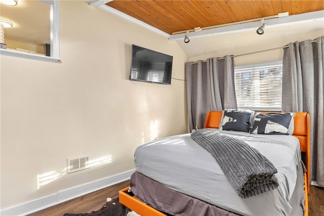 bedroom with dark wood-type flooring, lofted ceiling, wood ceiling, and track lighting