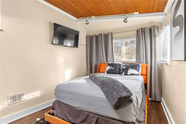 bedroom featuring dark hardwood / wood-style flooring, vaulted ceiling, wooden ceiling, and rail lighting