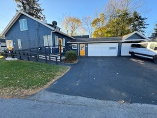 view of front of house with a garage and a front yard