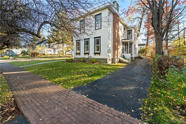 view of home's exterior with a lawn