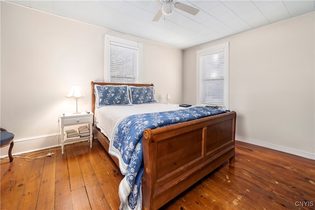 bedroom featuring ceiling fan and dark hardwood / wood-style floors