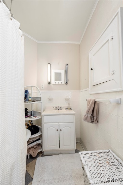 bathroom with tile walls, a shower with shower curtain, vanity, and crown molding