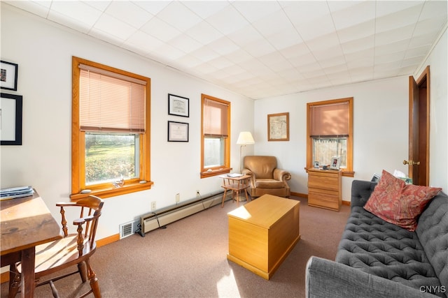 carpeted living room with a baseboard heating unit