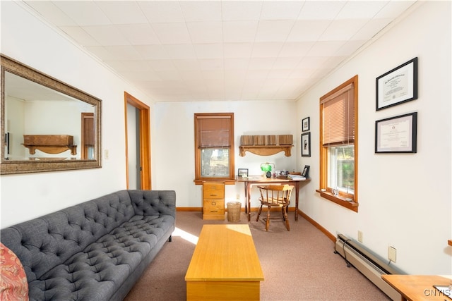 living room with a baseboard heating unit, carpet flooring, and crown molding