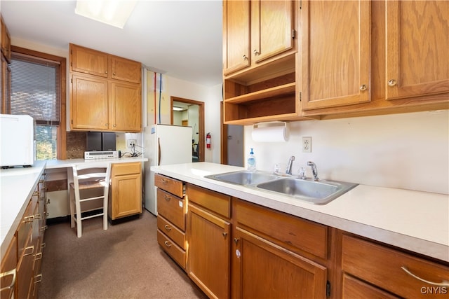 kitchen featuring sink and dark carpet