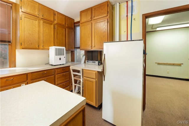 kitchen with dark colored carpet and white refrigerator