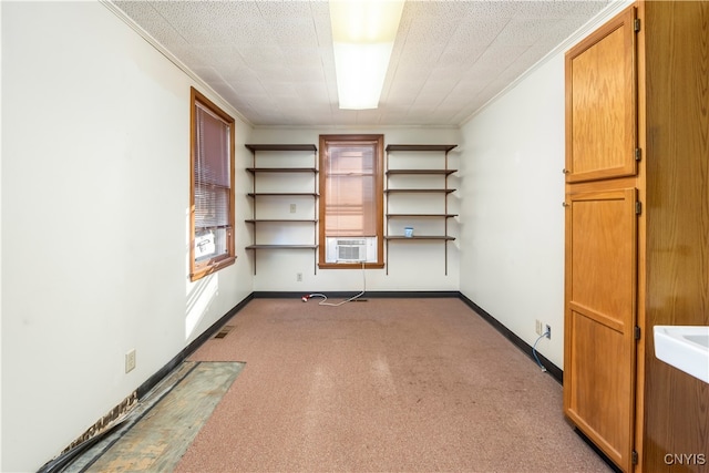 interior space featuring cooling unit, a textured ceiling, and crown molding