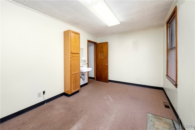 unfurnished bedroom featuring ornamental molding and light colored carpet