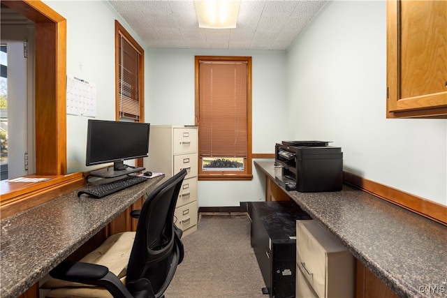 carpeted office featuring a textured ceiling