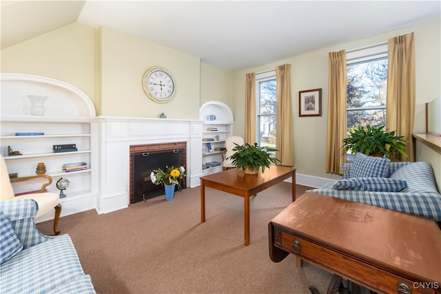 carpeted living room featuring a fireplace, plenty of natural light, and lofted ceiling