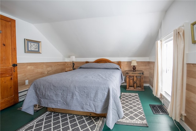 bedroom with a baseboard radiator, wood walls, dark hardwood / wood-style floors, and vaulted ceiling