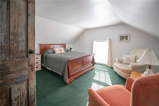 bedroom featuring multiple windows, vaulted ceiling, and dark carpet