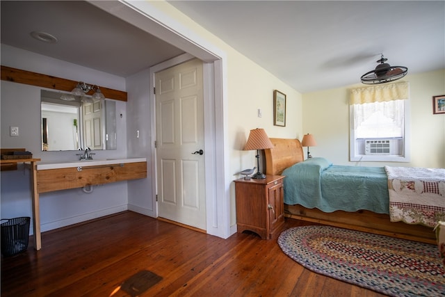 bedroom featuring dark wood-type flooring and cooling unit