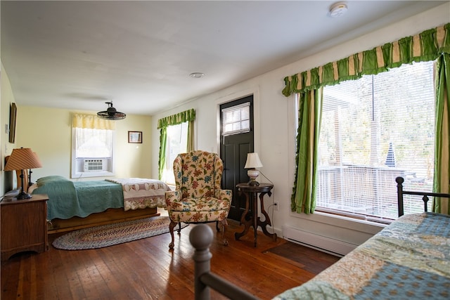 bedroom with dark wood-type flooring and multiple windows