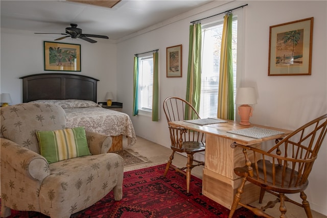 bedroom featuring ceiling fan and ornamental molding