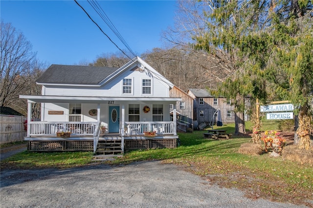 view of front of property with a porch and a front lawn