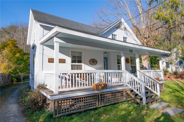 view of front of home with a porch and cooling unit