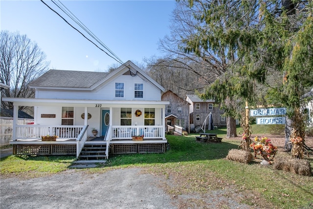 view of front of home with a front lawn and a porch