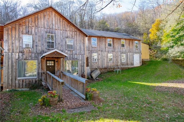 back of property featuring a yard