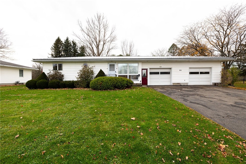 ranch-style house with a front lawn and a garage