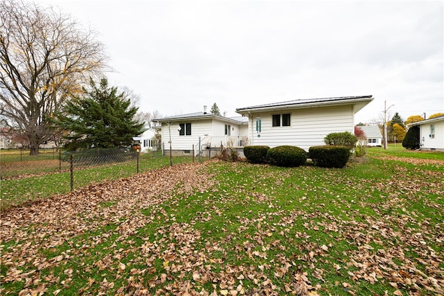 rear view of house featuring a lawn