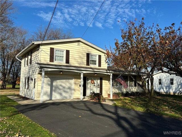 view of front of property featuring a garage and a porch