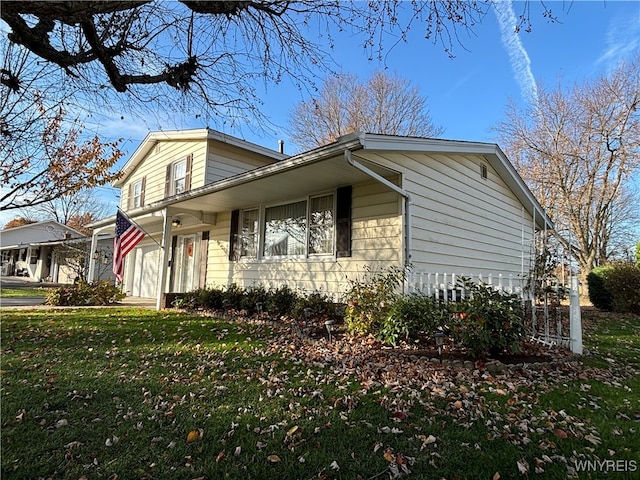 view of property exterior featuring a lawn