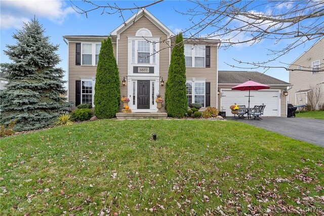 view of front facade with a front yard and a garage