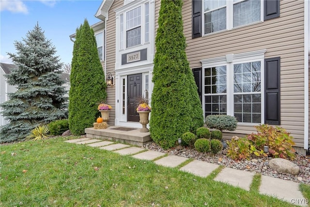 entrance to property featuring a yard