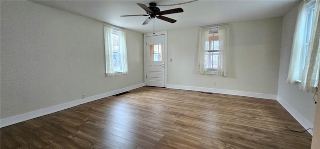 spare room with hardwood / wood-style floors, plenty of natural light, and ceiling fan