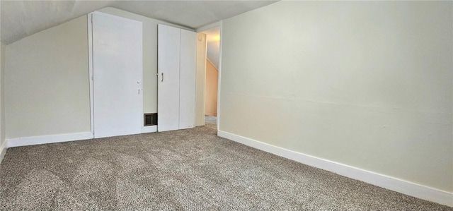 additional living space featuring lofted ceiling and carpet floors