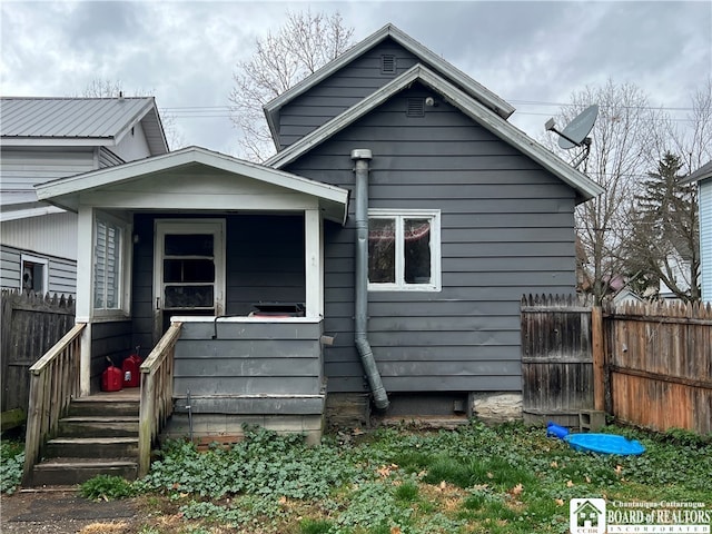 back of house featuring covered porch