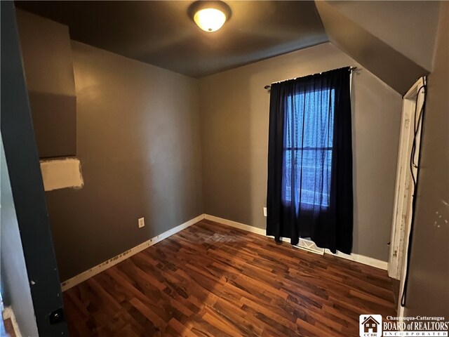 empty room with dark hardwood / wood-style flooring