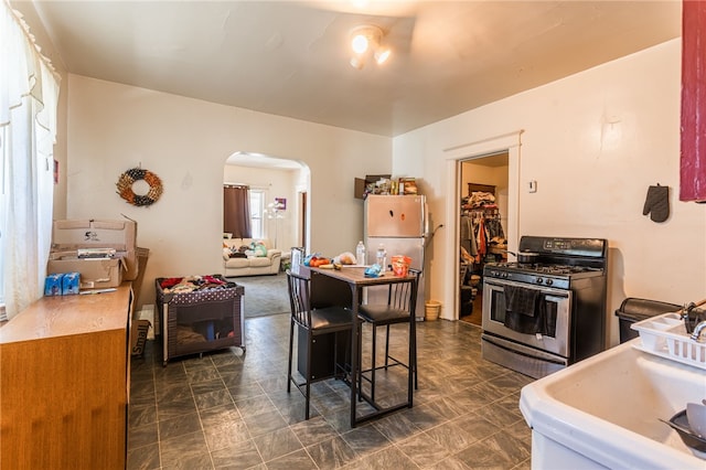 kitchen with sink, a breakfast bar, and appliances with stainless steel finishes