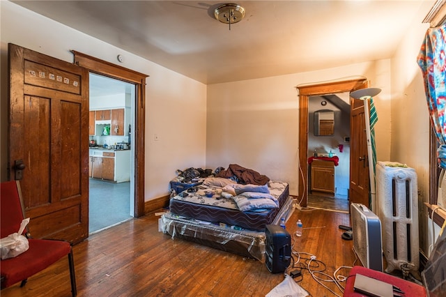 living area featuring dark hardwood / wood-style flooring and radiator