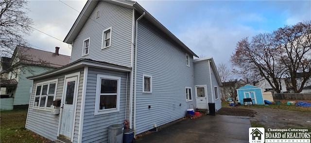 view of home's exterior with a storage unit