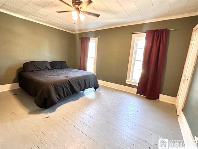 bedroom featuring ceiling fan, light wood-type flooring, and crown molding