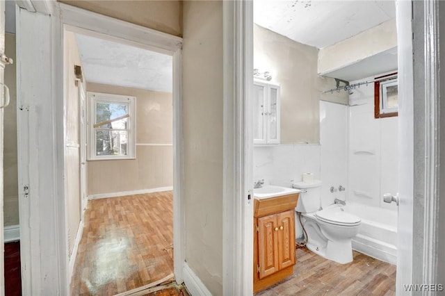 full bathroom with shower / bathing tub combination, toilet, vanity, and hardwood / wood-style flooring