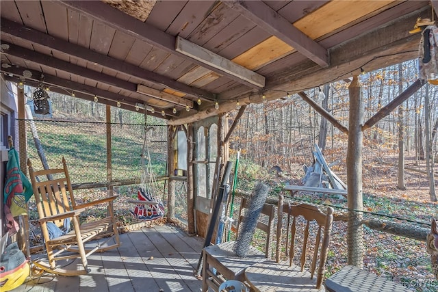 unfurnished sunroom with beamed ceiling and wooden ceiling