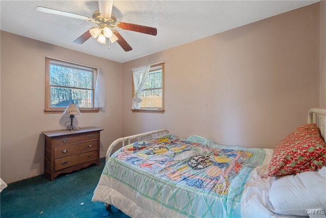 bedroom featuring ceiling fan and dark carpet