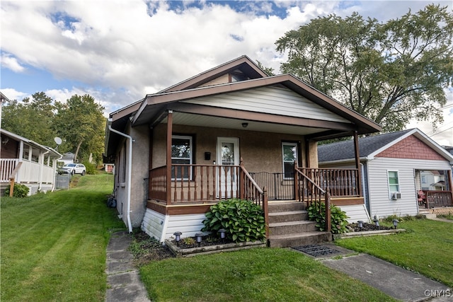 bungalow-style home featuring a front lawn and covered porch