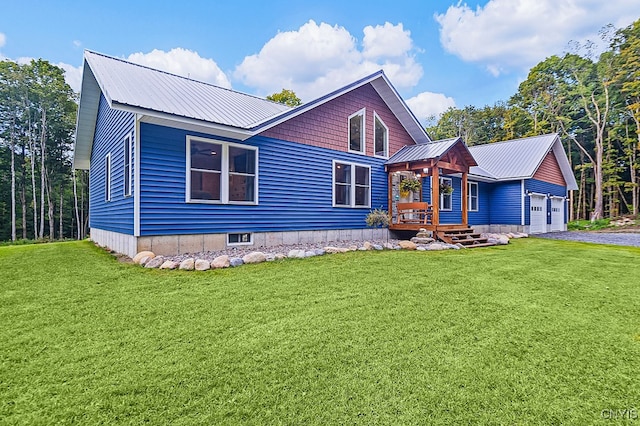 view of front of home with a garage, a front yard, and a porch